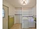 The laundry room features shelving, tile flooring, and a washer and dryer at 1207 Norwich Cir, Sun City Center, FL 33573