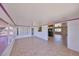Bright, open living room with tiled floors, and seamless flow into the sunroom and kitchen areas at 1207 Norwich Cir, Sun City Center, FL 33573