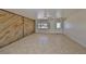 Spacious living room with tile flooring, wood accent wall, neutral paint, and a bright front window at 1207 Norwich Cir, Sun City Center, FL 33573