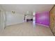 Bright living room with tile flooring and unique accent wall; ceiling fan present at 1207 Norwich Cir, Sun City Center, FL 33573