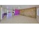 Open concept living space with unique decor, including wood paneling and brightly colored accent walls at 1207 Norwich Cir, Sun City Center, FL 33573