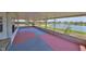 Enclosed patio with views of the water, colorful concrete flooring, and screened windows at 1207 Norwich Cir, Sun City Center, FL 33573