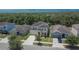 Suburban neighborhood featuring well-maintained homes with manicured lawns, driveways, and surrounded by lush trees and greenery at 12150 Ledbury Commons Dr, Gibsonton, FL 33534