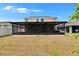 Large screened-in lanai overlooking the expansive backyard, ideal for enjoying the outdoors year-round at 12150 Ledbury Commons Dr, Gibsonton, FL 33534