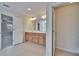 Bright bathroom with a double vanity, tiled floors and a view to the bedroom and water closet at 12150 Ledbury Commons Dr, Gibsonton, FL 33534