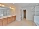 Bright bathroom with a double vanity, walk-in shower, and tiled floors at 12150 Ledbury Commons Dr, Gibsonton, FL 33534