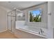 Bright bathroom with a walk-in shower, soaking tub, and natural light at 12150 Ledbury Commons Dr, Gibsonton, FL 33534