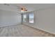 Bedroom with carpet floor, ceiling fan, and abundant natural light from two windows at 12150 Ledbury Commons Dr, Gibsonton, FL 33534
