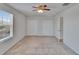 Bedroom with natural light, carpet floors, ceiling fan and bi-fold closet doors at 12150 Ledbury Commons Dr, Gibsonton, FL 33534