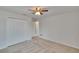 Bedroom with bi-fold closet, connecting door, carpet, neutral walls, and a ceiling fan at 12150 Ledbury Commons Dr, Gibsonton, FL 33534