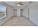 Bedroom with large window, carpet floors, ceiling fan and bi-fold closet doors at 12150 Ledbury Commons Dr, Gibsonton, FL 33534