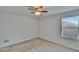 Bedroom featuring a window overlooking a neighborhood, neutral walls, carpet, and ceiling fan at 12150 Ledbury Commons Dr, Gibsonton, FL 33534