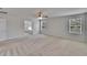 Spacious bedroom features neutral walls, carpet, a ceiling fan, and an ensuite bathroom at 12150 Ledbury Commons Dr, Gibsonton, FL 33534