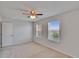 Bedroom featuring two windows overlooking a neighborhood, neutral walls, carpet, and ceiling fan at 12150 Ledbury Commons Dr, Gibsonton, FL 33534