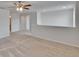 Bonus room features neutral walls, carpet, a ceiling fan, and plenty of natural light at 12150 Ledbury Commons Dr, Gibsonton, FL 33534