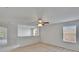 Bonus room features neutral walls, carpet, a ceiling fan, and plenty of natural light at 12150 Ledbury Commons Dr, Gibsonton, FL 33534
