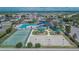 Aerial view showcasing the community's amenities: pool, tennis courts, playground, and basketball court at 12150 Ledbury Commons Dr, Gibsonton, FL 33534