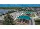 Community playground with shaded areas, basketball court, and tennis courts near a tranquil lake at 12150 Ledbury Commons Dr, Gibsonton, FL 33534