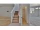 Bright entryway with a carpeted staircase, a hall closet, and tile flooring at 12150 Ledbury Commons Dr, Gibsonton, FL 33534