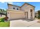 Two-story home with a two-car garage, neutral color scheme, and well-maintained landscaping at 12150 Ledbury Commons Dr, Gibsonton, FL 33534