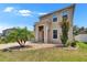 Two-story home with a covered entryway, well-manicured lawn, and decorative landscaping at 12150 Ledbury Commons Dr, Gibsonton, FL 33534