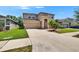 Two-story home featuring a neutral color palette, a two-car garage, and manicured landscaping at 12150 Ledbury Commons Dr, Gibsonton, FL 33534