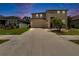 Charming home featuring a spacious driveway leading to a two-car garage, complemented by manicured landscaping and a welcoming entrance at 12150 Ledbury Commons Dr, Gibsonton, FL 33534