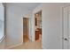 Hallway view of walk-in pantry with metal shelving and door leading to the kitchen at 12150 Ledbury Commons Dr, Gibsonton, FL 33534