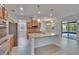 Bright kitchen with granite countertops, stainless steel appliances, and a spacious island with seating at 12150 Ledbury Commons Dr, Gibsonton, FL 33534