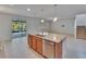 Updated kitchen island with stainless steel dishwasher and sink, and an open floorplan to the living room at 12150 Ledbury Commons Dr, Gibsonton, FL 33534
