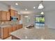 Modern kitchen with granite countertops, stainless steel appliances, and bright recessed lighting at 12150 Ledbury Commons Dr, Gibsonton, FL 33534