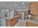 Open kitchen with stainless steel appliances and a spacious island with pendant lighting for a modern design at 12150 Ledbury Commons Dr, Gibsonton, FL 33534