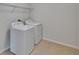 Bright laundry room with a full size washer and dryer at 12150 Ledbury Commons Dr, Gibsonton, FL 33534