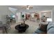 Open-concept living area with kitchen, dining, and a staircase featuring neutral colors and stylish decor at 12150 Ledbury Commons Dr, Gibsonton, FL 33534