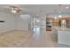 View of open concept living area, showing transition from carpeted area to the kitchen and staircase at 12150 Ledbury Commons Dr, Gibsonton, FL 33534