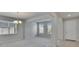 Bright living room featuring neutral walls, carpet flooring, natural light, and a view of the front door at 12150 Ledbury Commons Dr, Gibsonton, FL 33534