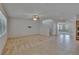 Open concept living room features tile floors, staircase, a ceiling fan, and lots of natural light at 12150 Ledbury Commons Dr, Gibsonton, FL 33534
