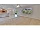 Open-concept living room with carpeted area, view to the screened-in patio, and adjacent kitchen at 12150 Ledbury Commons Dr, Gibsonton, FL 33534