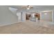 Spacious living room with carpet, tile floors, view to the kitchen, and stairs to the second floor at 12150 Ledbury Commons Dr, Gibsonton, FL 33534