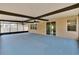 Spacious screened patio featuring ceiling fans, painted floor, and access to the home's interior and the backyard at 12150 Ledbury Commons Dr, Gibsonton, FL 33534