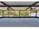 Screened patio showcasing a spacious area, ceiling fans, and serene outdoor view at 12150 Ledbury Commons Dr, Gibsonton, FL 33534
