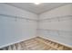 Spacious walk-in closet with custom shelving and carpeted floors at 12150 Ledbury Commons Dr, Gibsonton, FL 33534
