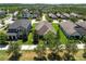 An aerial view showcases the property in a well-maintained neighborhood with mature trees at 12462 Rangeland Blvd, Odessa, FL 33556