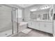 Elegant bathroom with a glass-enclosed shower, soaking tub, and double vanity, offering a spa-like experience at 12462 Rangeland Blvd, Odessa, FL 33556