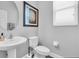 Powder room with a pedestal sink and a decorative mirror at 12462 Rangeland Blvd, Odessa, FL 33556