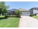Charming home with a screened-in lanai, a two-car garage, and beautiful landscaping at 12462 Rangeland Blvd, Odessa, FL 33556