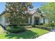 A beautiful home boasts meticulously maintained landscaping, a rocking chair porch, and classic curb appeal at 12462 Rangeland Blvd, Odessa, FL 33556
