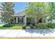 Charming single-story home with manicured lawn, lush trees, and beautiful front garden at 12462 Rangeland Blvd, Odessa, FL 33556