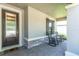 Inviting front porch with stone accents and two rocking chairs at 12462 Rangeland Blvd, Odessa, FL 33556