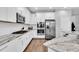 Modern kitchen with white cabinets, stainless steel appliances and wood flooring at 12462 Rangeland Blvd, Odessa, FL 33556